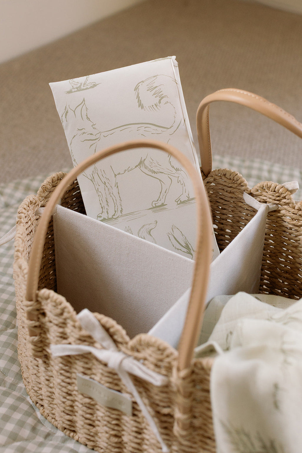 Woven basket with stationery items on a neutral background