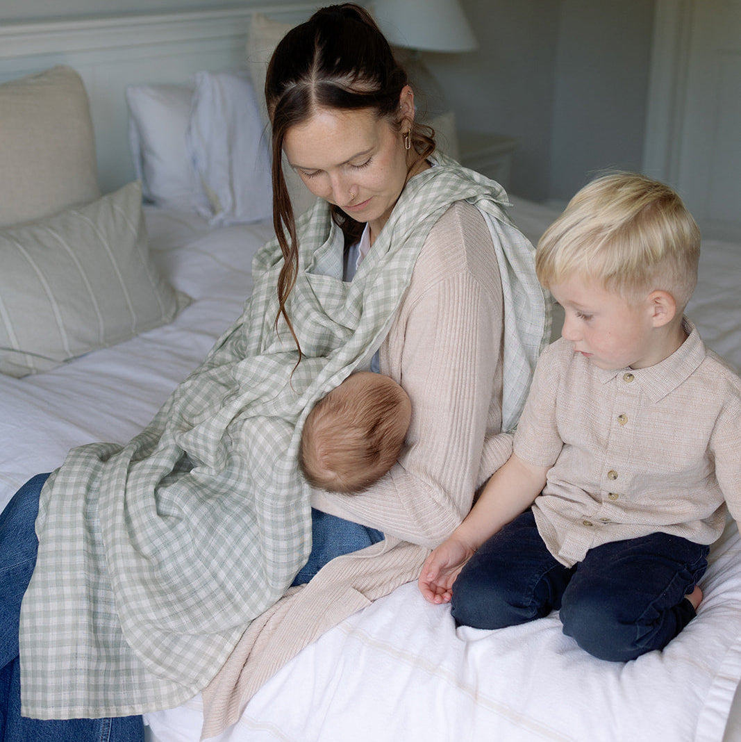 Woman and child sitting on a bed in a bedroom
