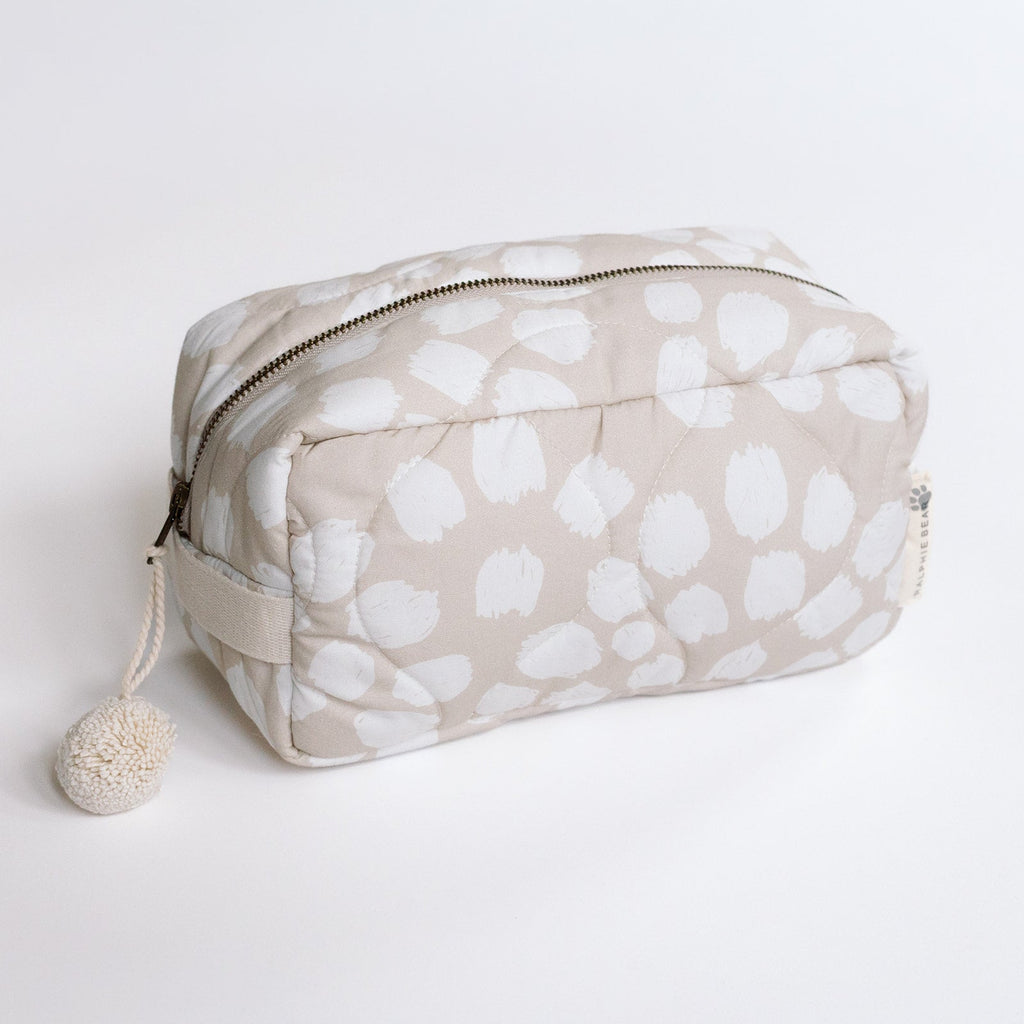 Cosmetic bag with white abstract pattern on beige background