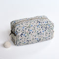 Floral-patterned toiletry bag on a white background