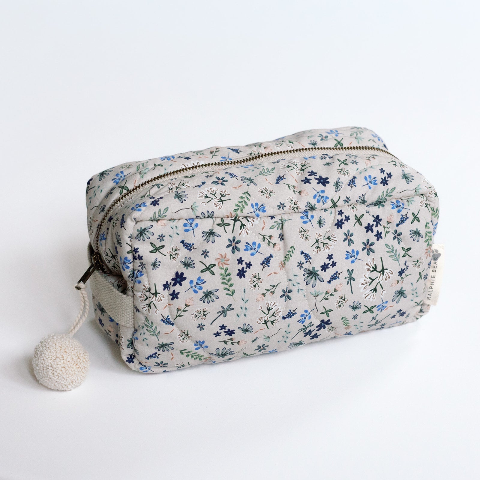 Floral-patterned toiletry bag on a white background