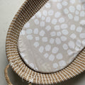 Woven basket with a patterned mat on a neutral background