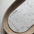 Woven basket with a mat featuring bear illustrations and 'Ralphie Bear' branding on a light background.