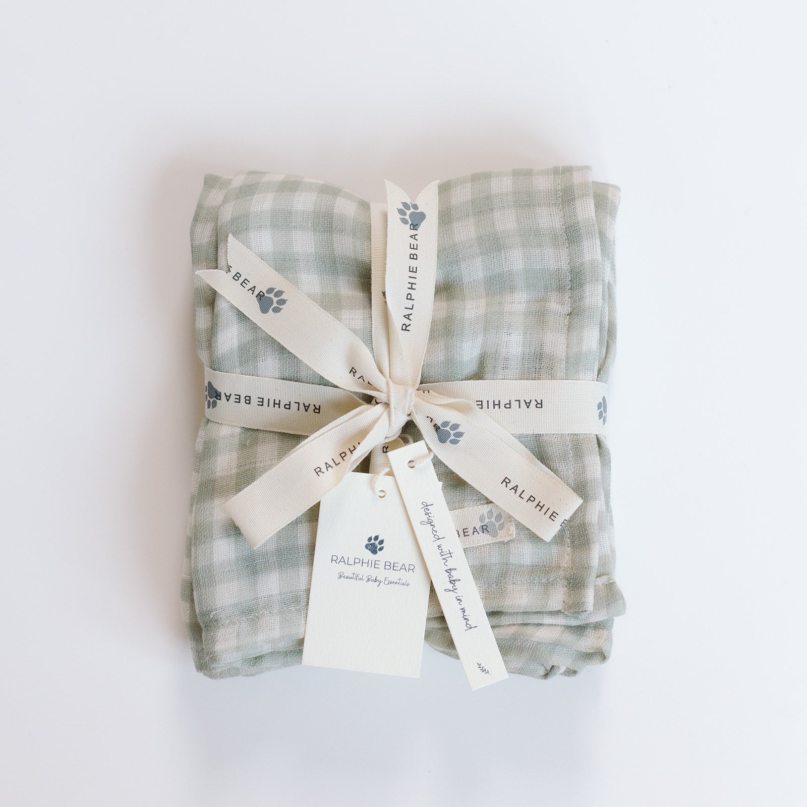 Packaged baby blanket with checkered pattern and 'Ralphie Bear' branding on a white background