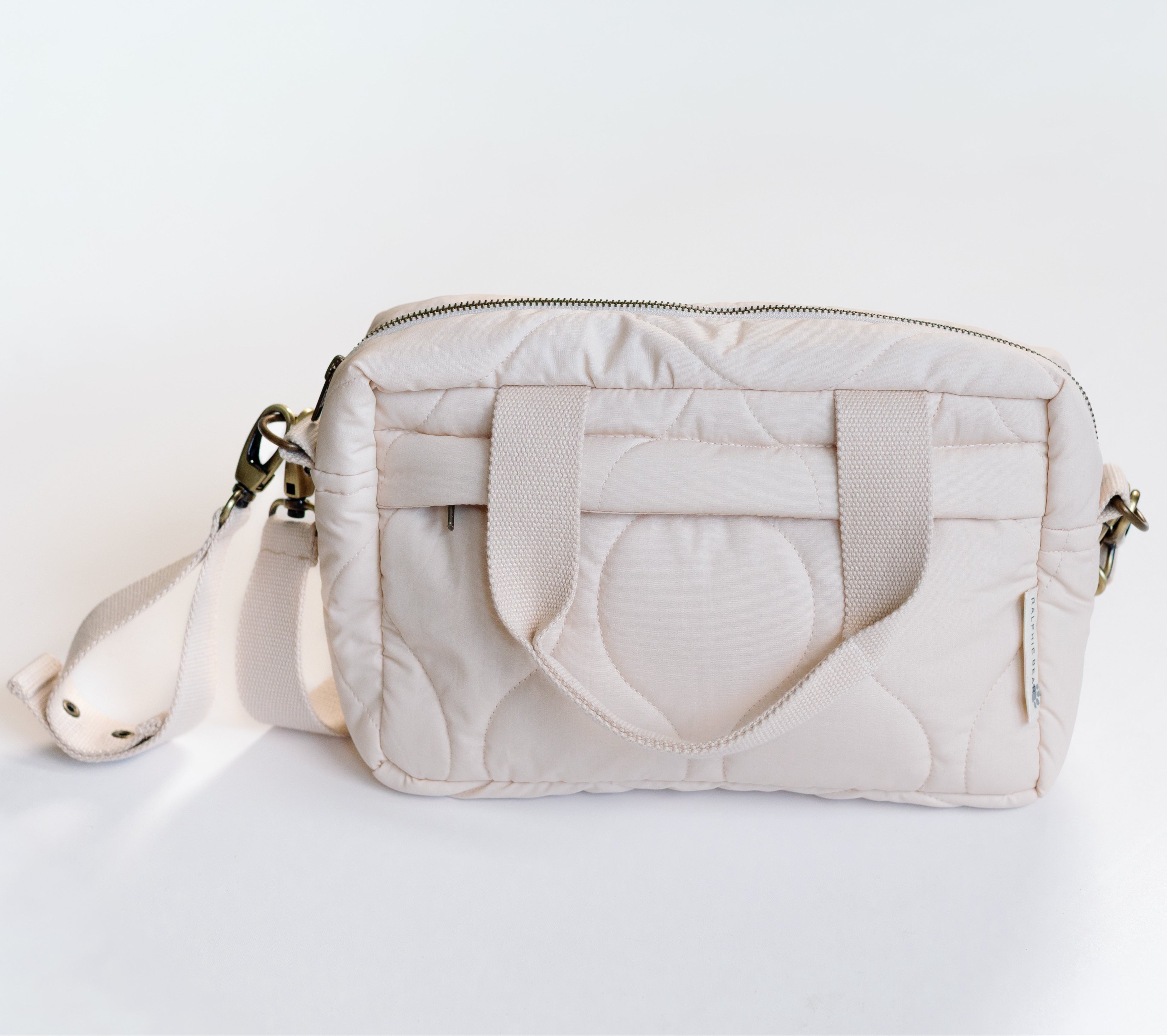 White quilted handbag on a light gray background
