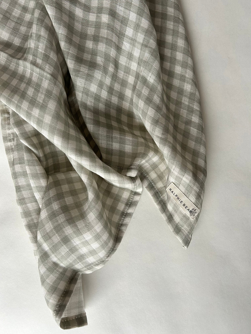 Plaid fabric with a visible brand label on a white background