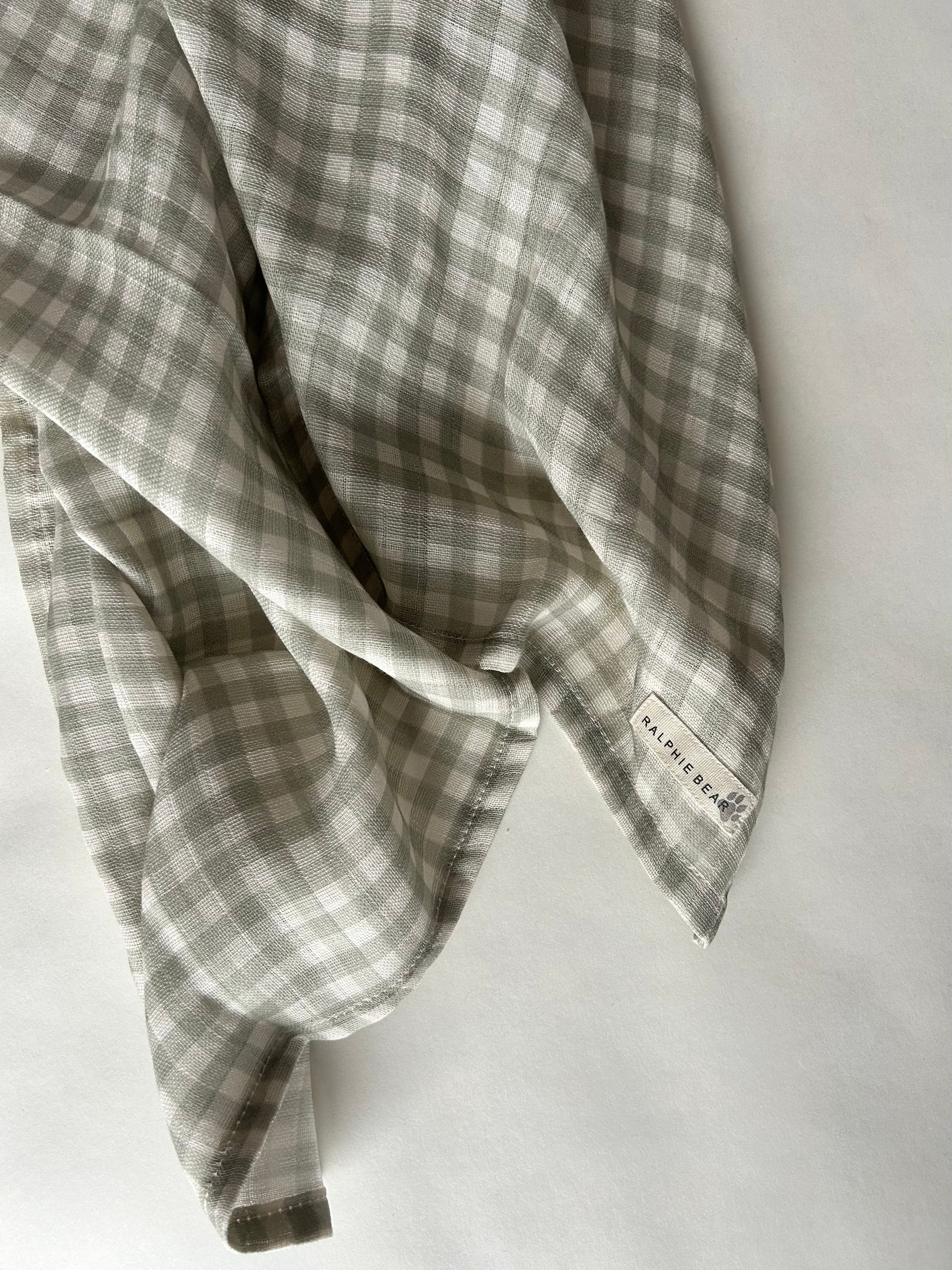 Plaid fabric with a visible brand label on a white background