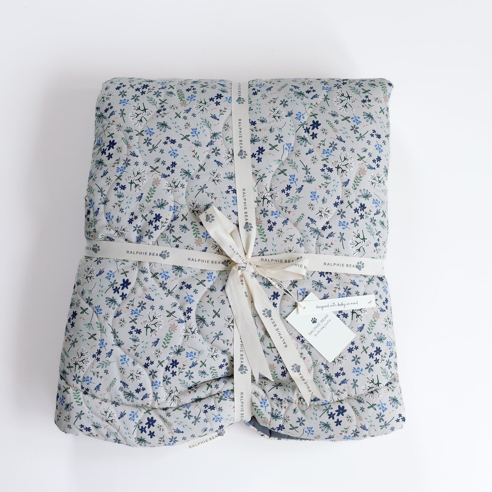 Folded floral fabric with a ribbon on a white background