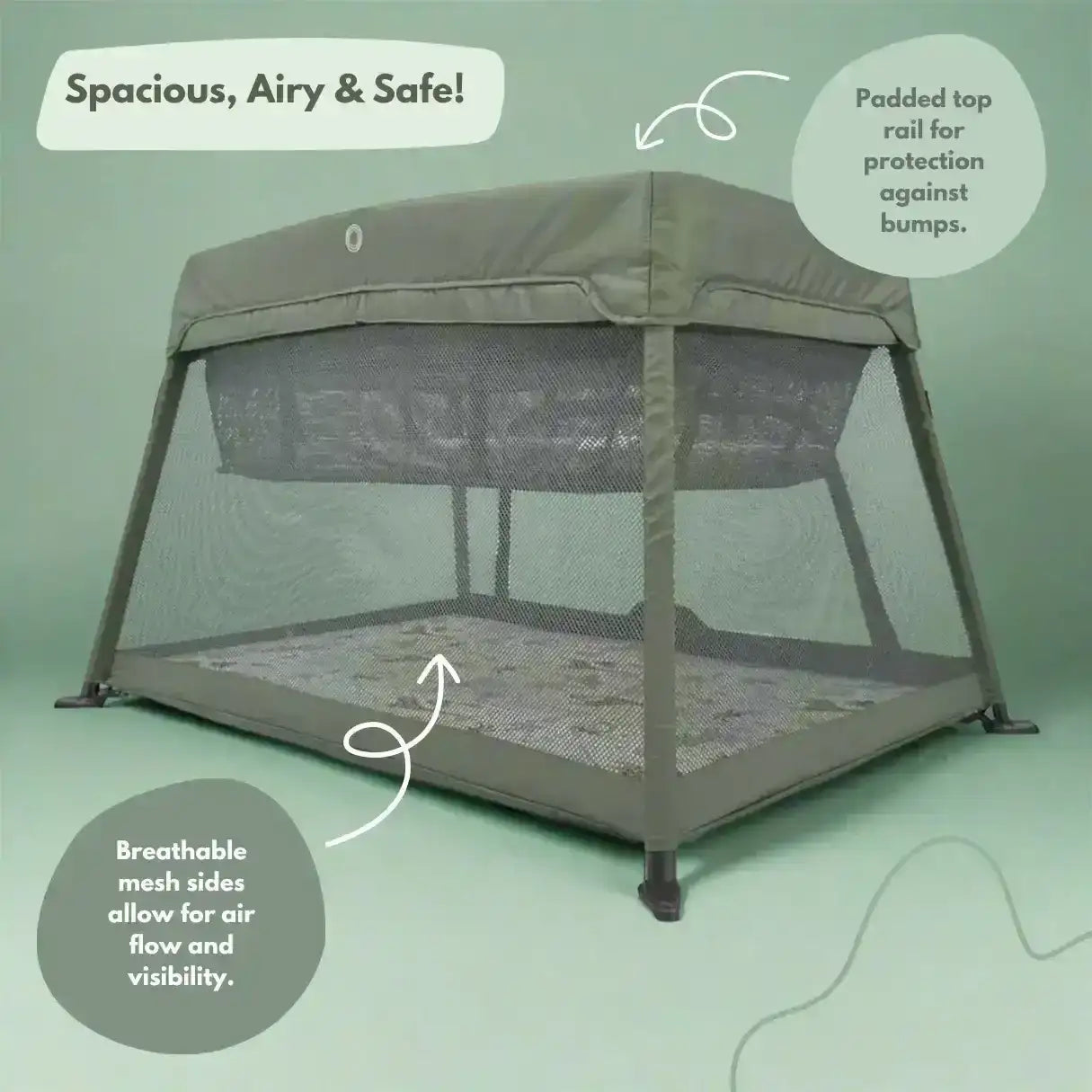 Portable crib with mesh sides and top rail on a green background