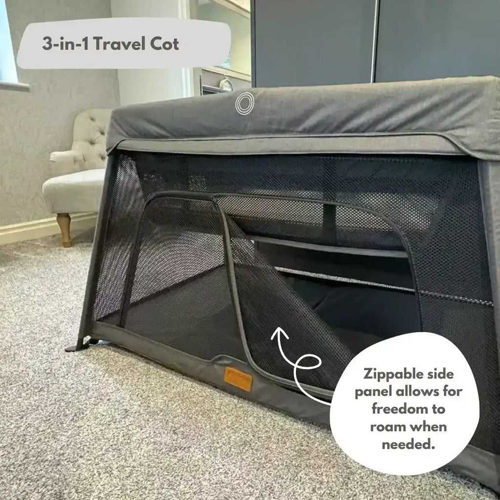 3-in-1 travel cot with zippable side panel in a room setting