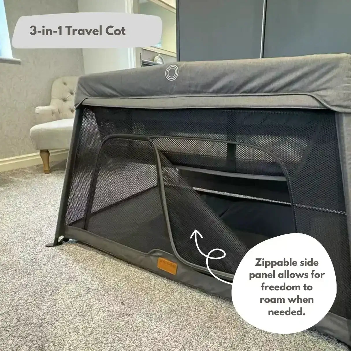 3-in-1 travel cot with zippable side panel in a room setting