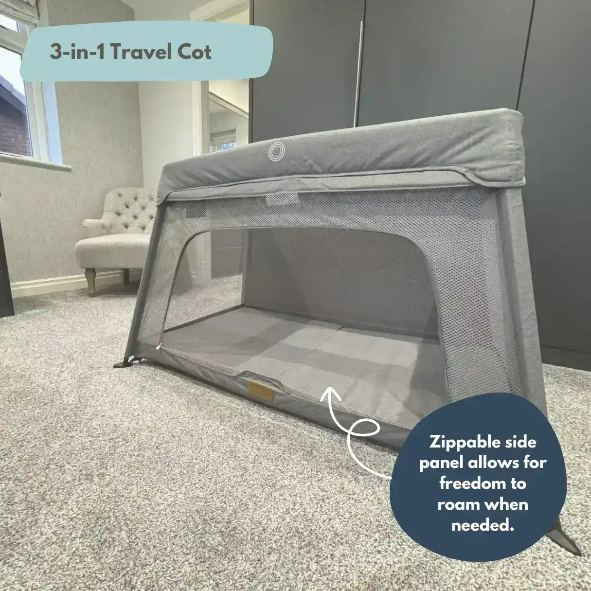 3-in-1 travel cot with zippable side panel in a room setting