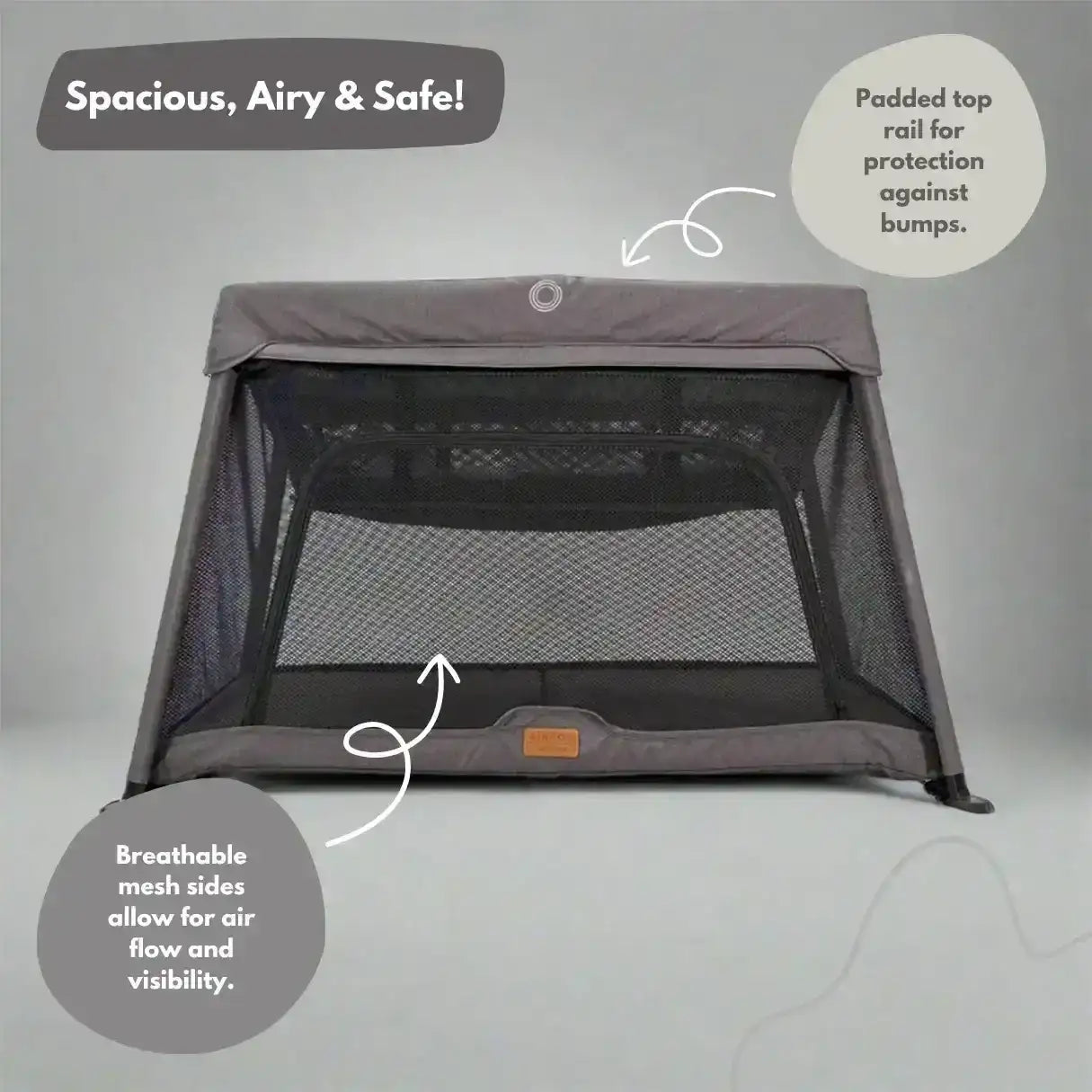 Portable crib with mesh sides and top rail on a gray background