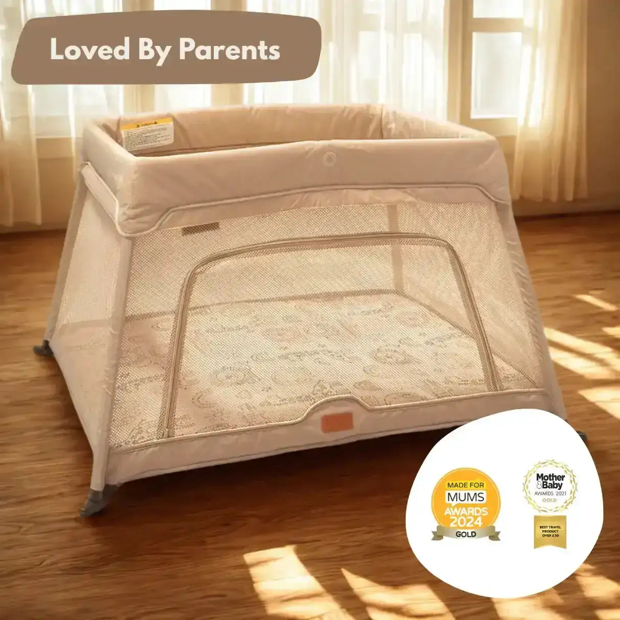 Beige baby playpen on a wooden floor with 'Loved By Parents' text and awards displayed.