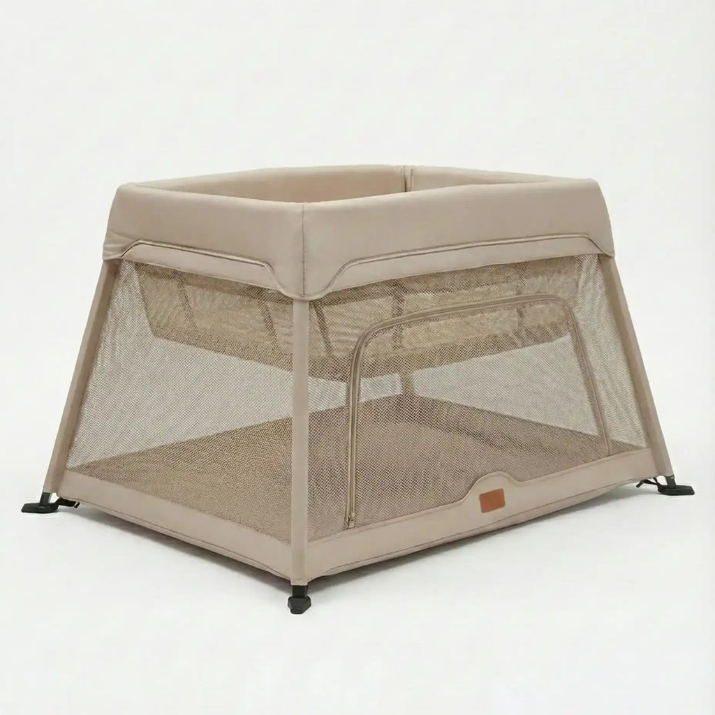 Beige baby crib with mesh sides on a white background