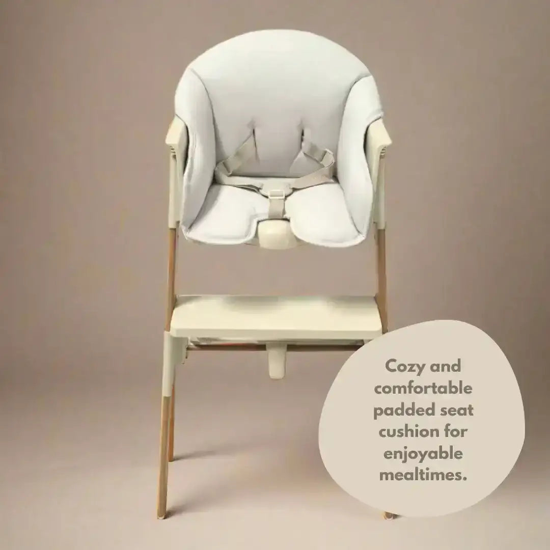 Baby high chair with a padded seat cushion on a beige background