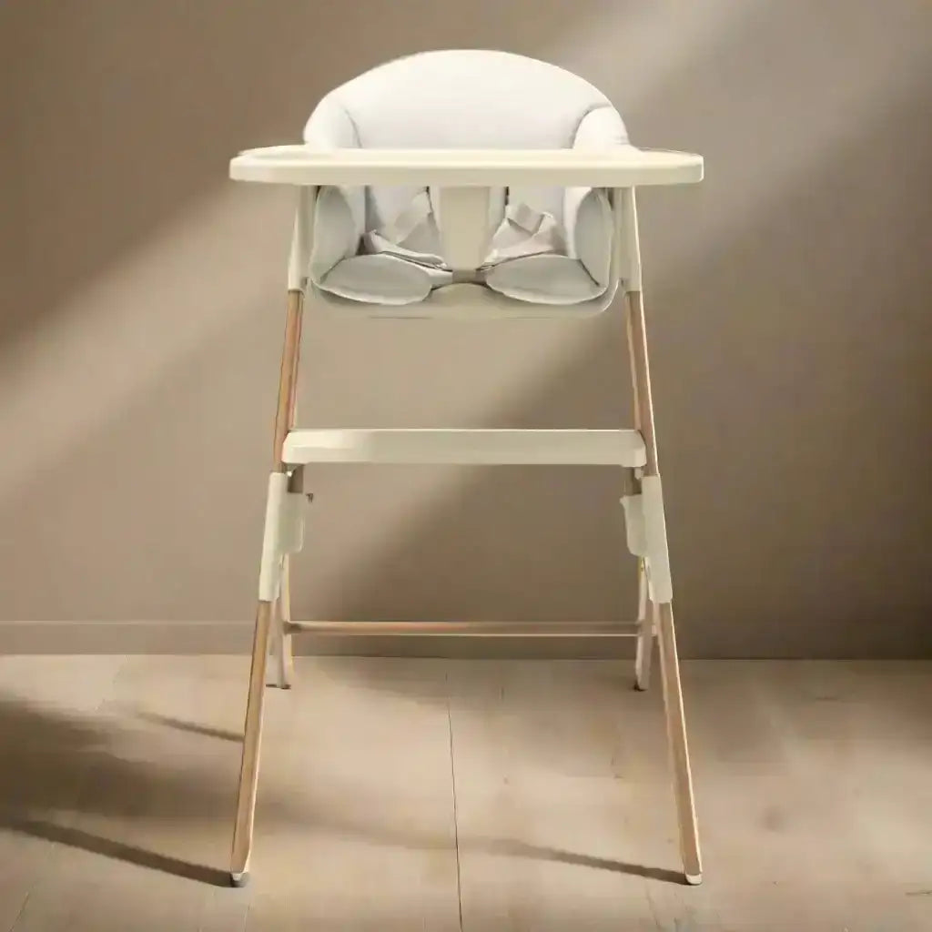 Baby high chair with a gray cushion on a neutral background