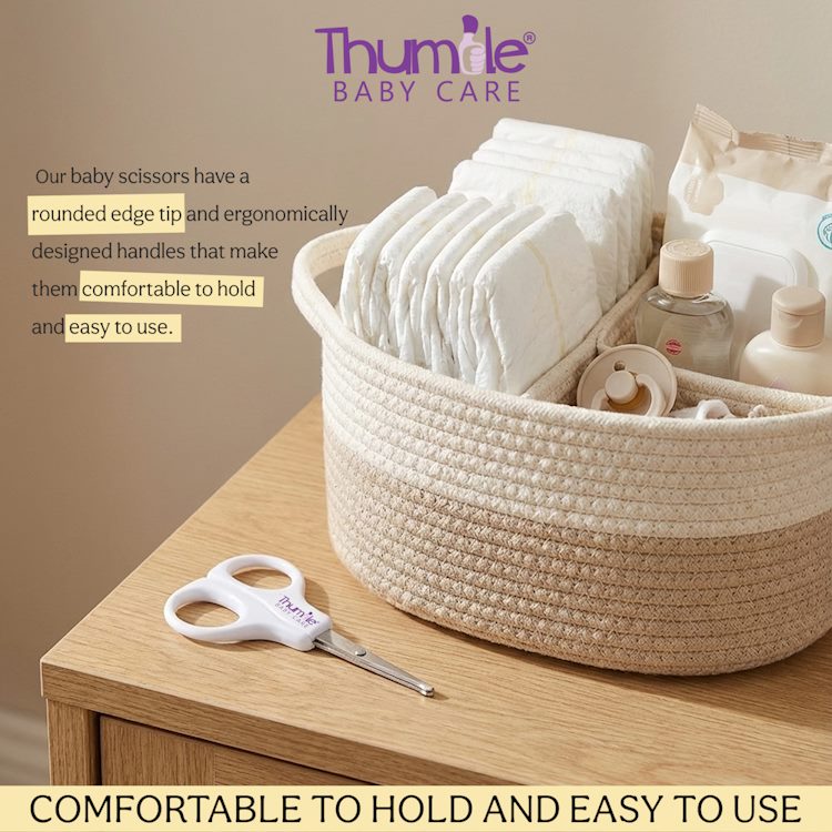 Basket of baby items with Thumile baby scissors on a wooden surface