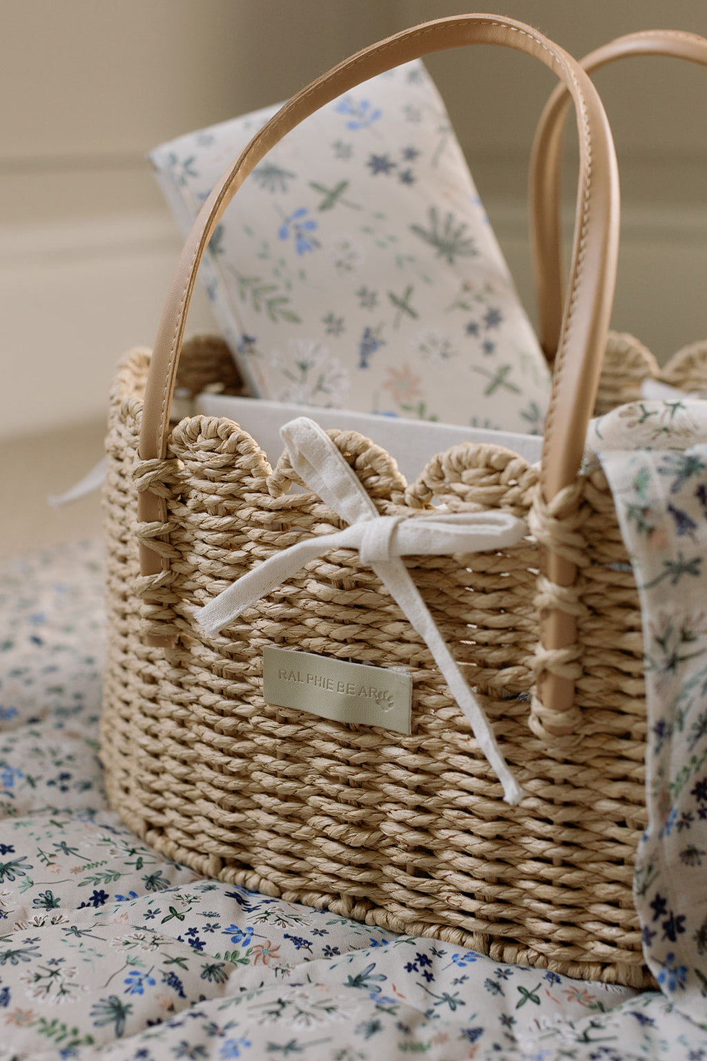 Woven basket with floral patterned fabric on a floral surface