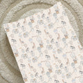 Changing mat with animal and hot air balloon pattern on a textured surface