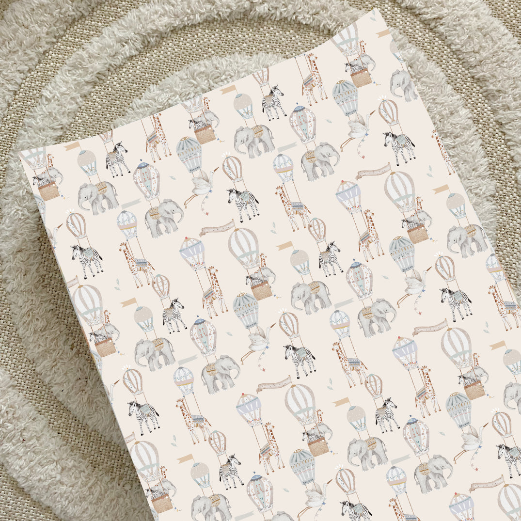 Changing mat with animal and hot air balloon pattern on a textured surface