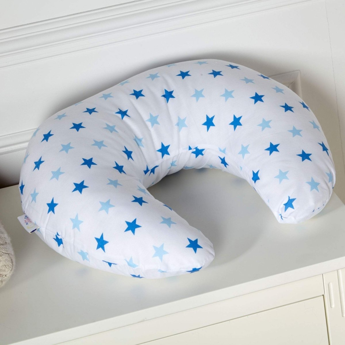 U-shaped pillow with star pattern on a white surface