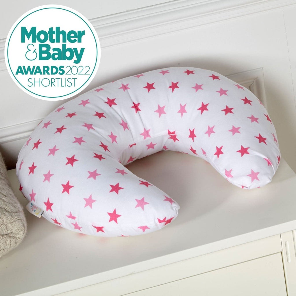 U-shaped pillow with pink star pattern on a white surface, featuring the Mother & Baby Awards 2022 Shortlist logo.