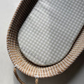 Wicker baby crib with a gray checkered mattress, branded 'Ralphie Bear'.