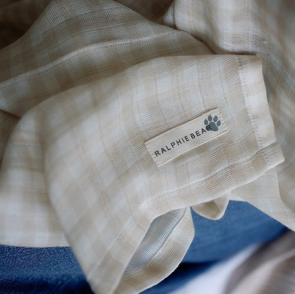 Beige fabric with a Ralphie & Bear label on a blue background